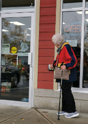 A person using the new automatic door opener at Bosley's in Comox